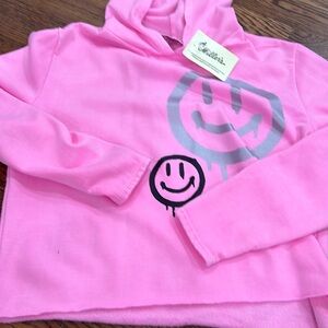 Cute pink hoodie with smiley faces on it